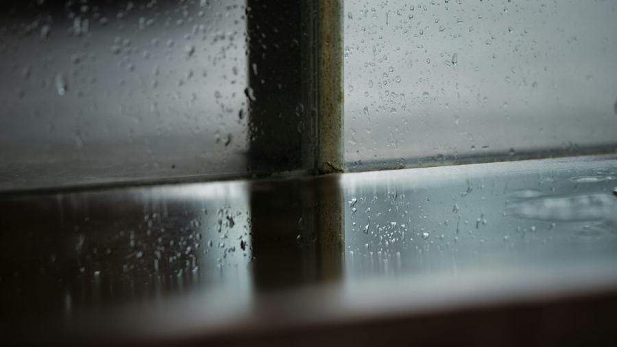 Água da chuva acumulada no peitoril de uma janela